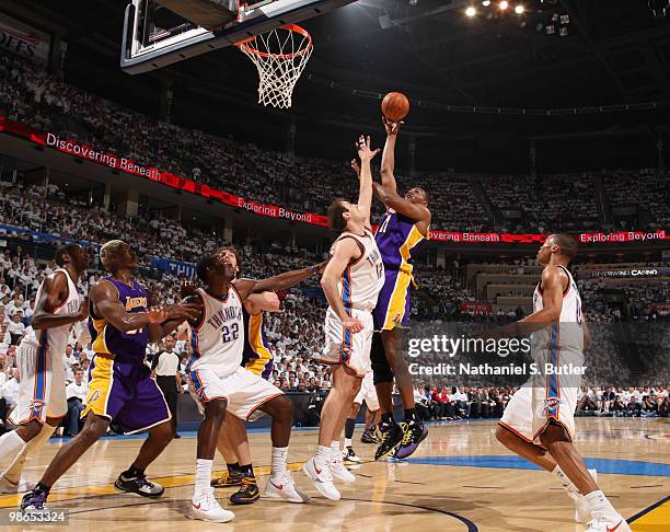 Andrew Bynum of the Los Angeles Lakers shoots against Nenad Krstic of the Oklahoma City Thunder as Pau Gasol, Jeff Green and Ron Artest position for...