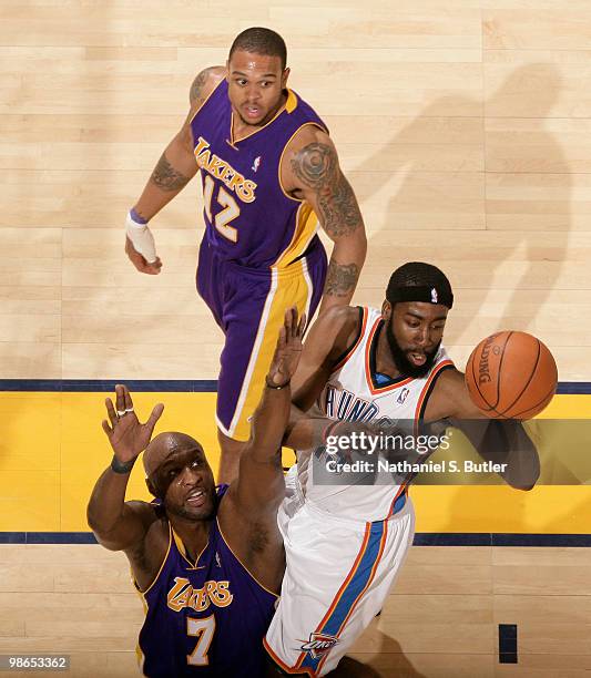 James Harden of the Oklahoma City Thunder passes against Lamar Odom and Shannon Brown of the Los Angeles Lakers in Game Four of the Western...