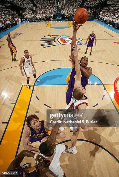 Andrew Bynum of the Los Angeles Lakers shoots against Nenad Krstic of the Oklahoma City Thunder as Pau Gasol and Jeff Green position for a rebound in...