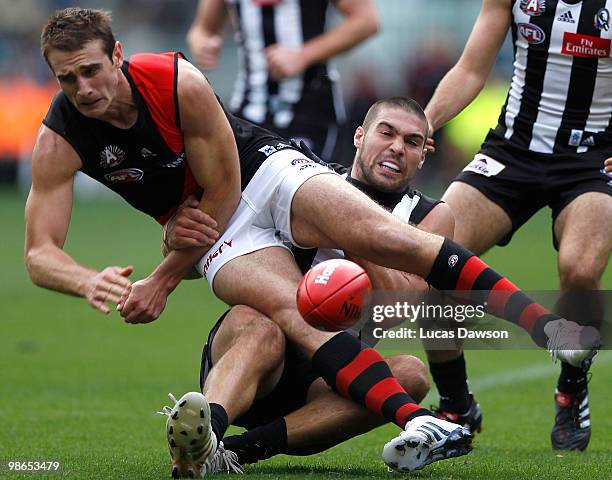 Jobe Watson of the Bombers is tackled be Chris Dawes of ther Magpies during the round five AFL match between the Collingwood Magpies and the Essendon...