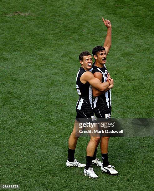 Luke Ball congratulates Sharrod Wellingham of the Magpies on scoring a goal during the round five AFL match between the Collingwood Magpies and the...