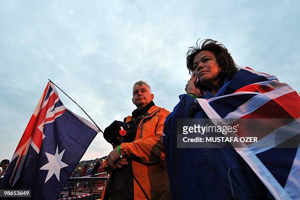 Australians hold their national flags as they attend a ceremony commemorating Anzac Day, at Anzac Cove, in western Canakkale on April 25, 2010. Anzac...