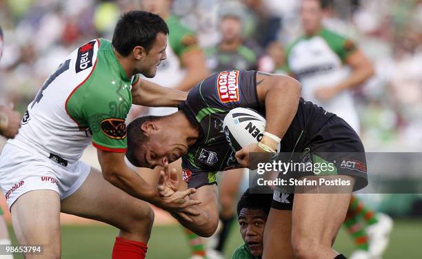 Tom Learoyd-Lahrs of the Raiders is tackled by Beau Champion of the Rabbitohs during the round seven NRL match between the Canberra Raiders and the...