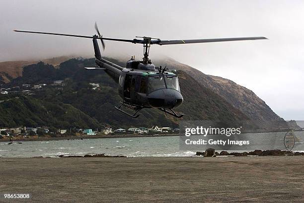 Royal New Zealand Air Force Iroquois helicopter leaves for Ohakea Air Base beneath the site of the accident of an Iroquois helicopter after it...