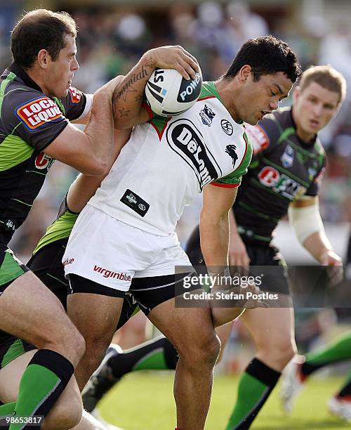 Issac Luke of the Rabbitohs is tackled by Terry Campese of the Raiders during the round seven NRL match between the Canberra Raiders and the South...