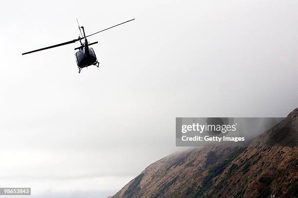 Royal New Zealand Air Force Iroquois helicopter leaves for Ohakea Air Base beneath the site of the accident of an Iroquois helicopter after it...