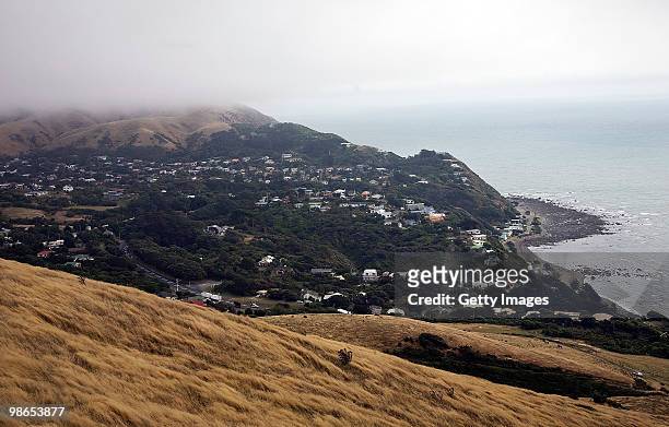Clouds cover the top of the hills above Pukerua Bay township where an Iroquois helicopter after it crashed into the hills of Pukerua Bay, Wellington...