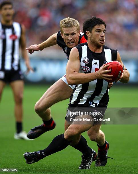 Dustin Fletcher of the Bombers attempts to tackle Paul Medhurst of the Magpies during the round five AFL match between the Collingwood Magpies and...