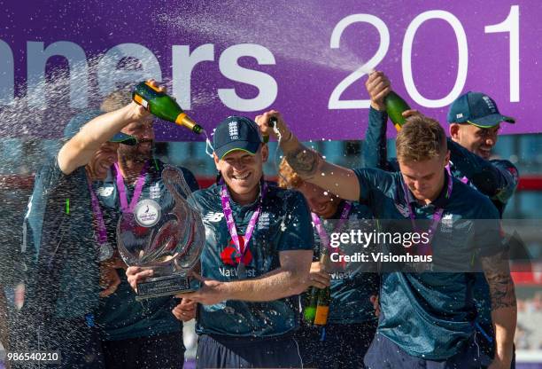 Captain Eoin Morgan holds the Royal London trophy as England celebrate the series win and 5-0 whitewash over Australia during the 5th Royal London...