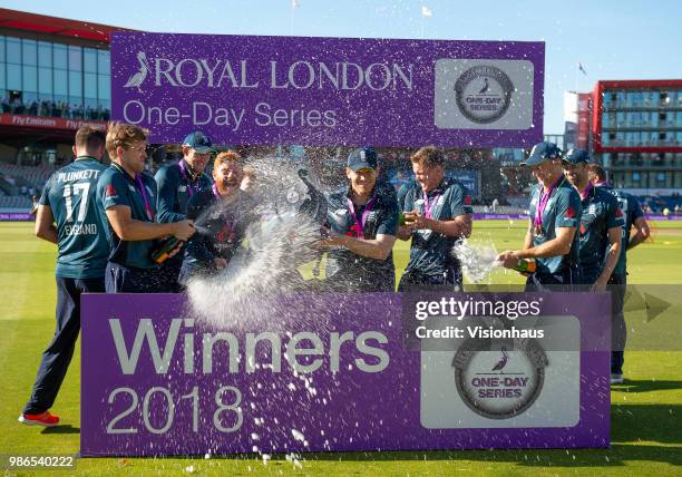 Captain Eoin Morgan holds the Royal London trophy as England celebrate the series win and 5-0 whitewash over Australia during the 5th Royal London...