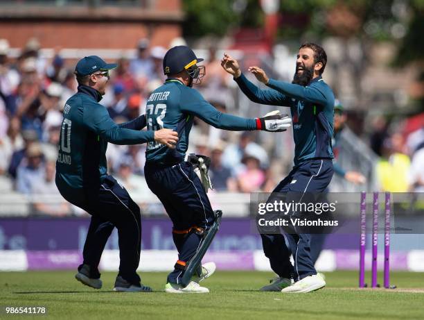 Moeen Ali of England celebrates with Jason Roy and Jos Buttler after taking the wicket of Tim Paine of Australia during the 5th Royal London ODI...