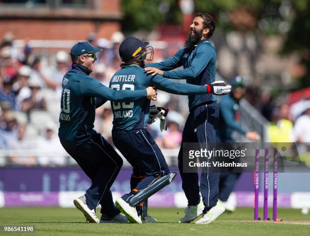 Moeen Ali of England celebrates with Jason Roy and Jos Buttler after taking the wicket of Tim Paine of Australia during the 5th Royal London ODI...