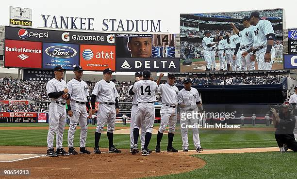 Curtis Granderson of the New York Yankees is greeted by manager Joe Girardi, Derek Jeter, Nick Johnson, Mark Teixeira, Alex Rodriguez, and Robinson...