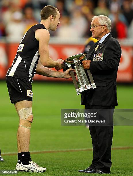 Nick Maxwell captain of the Magpies accepts the trophy having won the round five AFL match between the Collingwood Magpies and the Essendon Bombers...