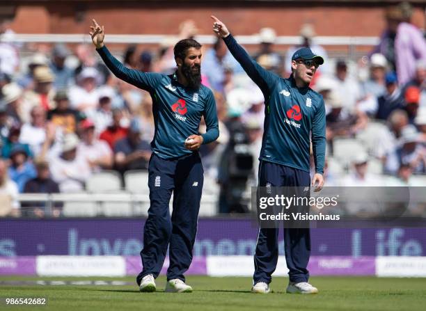 Moeen Ali and Eoin Morgan of England give instructions to the fielders during the 5th Royal London ODI between England and Australia at the Emirates...