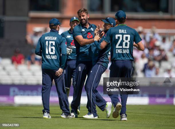 Liam Plunkett of England celebrates with Eoin Morgan after taking the wicket of Travis Head of Australia during the 5th Royal London ODI between...