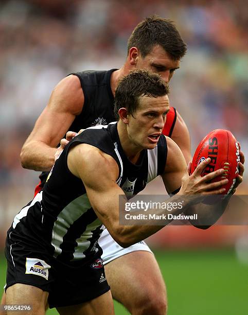 David Hille of the Bombers attempts to spoil Luke Ball of the Magpies during the round five AFL match between the Collingwood Magpies and the...