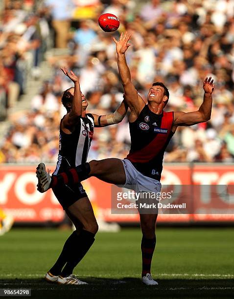 David Hille of the Bombers contests a centre bounce with Josh Fraser of the Magpies during the round five AFL match between the Collingwood Magpies...
