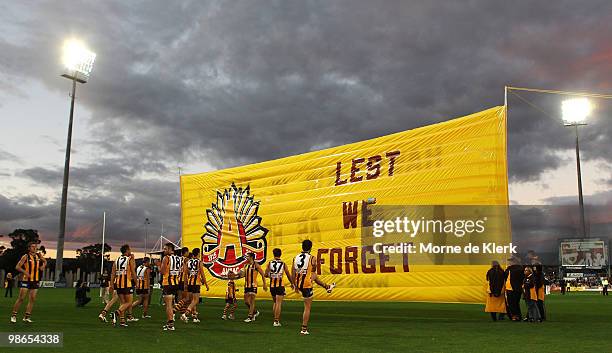 The Hawks run onto the field during the round five AFL match between the Hawthorn Hawks and the North Melbourne Kangaroos at Aurora Stadium on April...