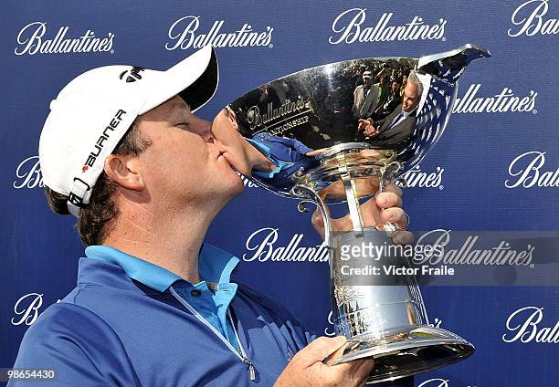 Marcus Fraser of Australia kisses the trophy after winning the Ballantine's Championship at Pinx Golf Club on April 25, 2010 in Jeju, South Korea.