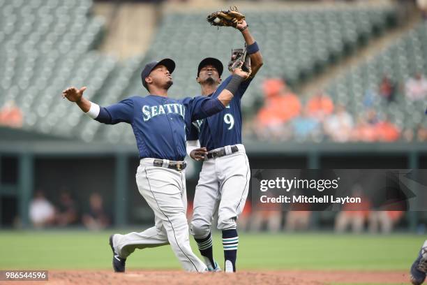 Dee Gordon of the Seattle Mariners catches a op up over Jean Segura on a Steve Wilkerson , hitted ball in the third inning during a baseball game...