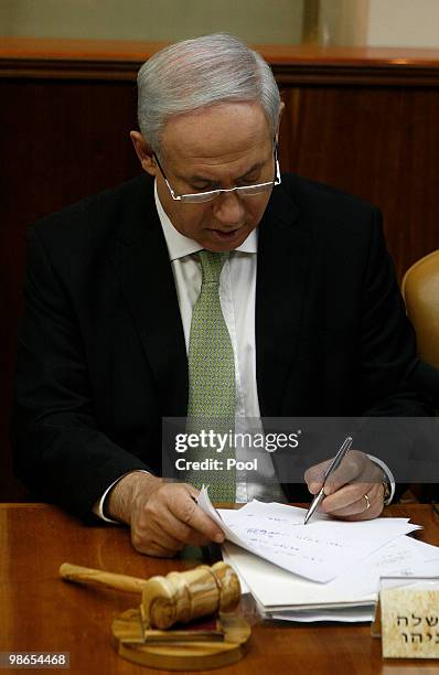 Israeli Prime Minister Benjamin Netanyahu makes notes ahead of the weekly cabinet meeting in his offices on April 25, 2010 in Jerusalem, Israel....