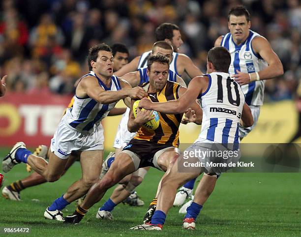 Campbell Brown of the Hawks runs with the ball, surrounded by opposition players of the Kangaroos during the round five AFL match between the...