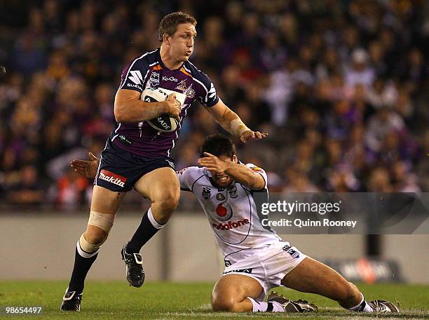 Ryan Hoffman of the Storm breaks through a tackle during the round seven NRL match between the Melbourne Storm and the Warriors at Etihad Stadium on...