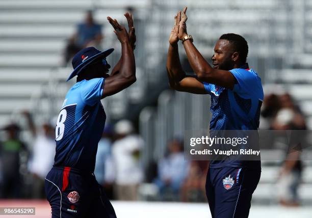 Kieron Pollard of Toronto Nationals celebrates the wicket of Chadwick Walton of Vancouver Knights with Darren Sammy during a Global T20 Canada match...