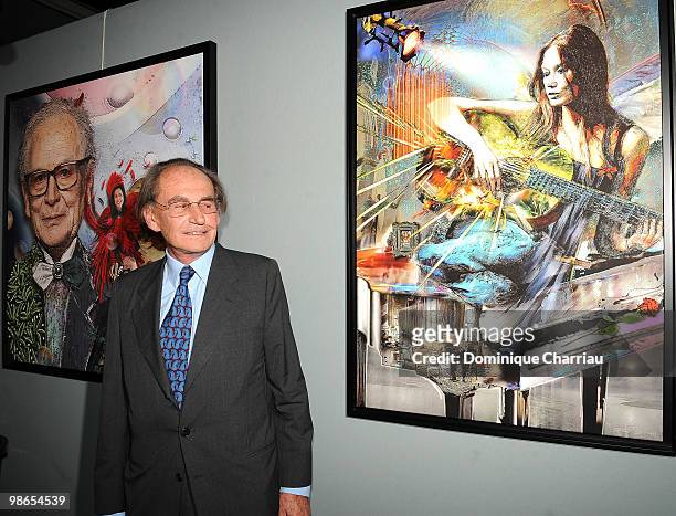 Pal Sarkozy poses with an artwork featuring his daughter in law, Carla Bruni, during the opening of his exhibition at Espace Pierre Cardin on April...