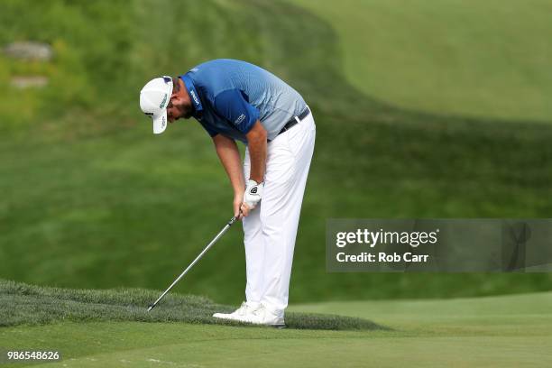 Marc Leishman of Australia reacts after a shot onto the 16th green during the first round of the Quicken Loans National at TPC Potomac on June 28,...