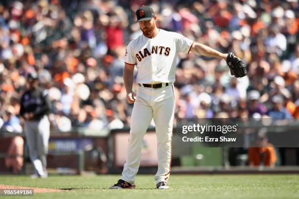 Sam Dyson of the San Francisco Giants reacts after he gave up a two-run home run to DJ LeMahieu of the Colorado Rockies in the ninth inning at AT&T...