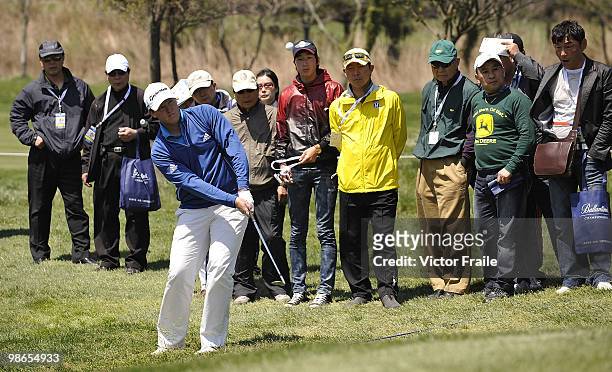 Marcus Fraser of Australia chips into the 11th green during the Round Three of the Ballantine's Championship at Pinx Golf Club on April 25, 2010 in...