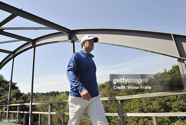 Marcus Fraser of Australia crosses a bridge on the 15th hole during the Round Three of the Ballantine's Championship at Pinx Golf Club on April 25,...