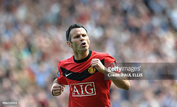 Manchester United's Welsh midfielder Ryan Giggs celebrates scoring a penalty against Tottenham Hotspur during their English Premier League football...