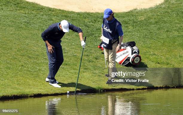 Henrik Stenson of Sweden recovers a ball from the water on the 2nd hole during the Round Three of the Ballantine's Championship at Pinx Golf Club on...