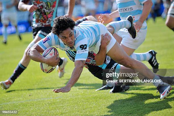 Stade Francais' hooker Mathieu Blin vies with Metro Racing's winger Mani Vakaloa during their French Top 14 rugby union match at the Charlety stadium...