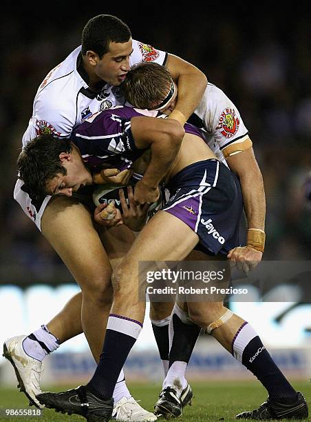 Matt Duffie of the Storm is tackled during the round seven NRL match between the Melbourne Storm and the Warriors at Etihad Stadium on April 25, 2010...