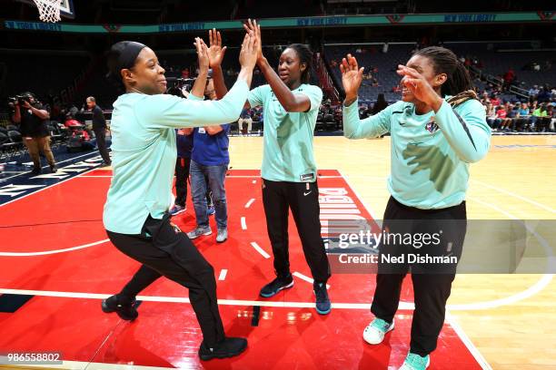 Kia Vaughn of the New York Liberty high-fives teammates before the game against the Washington Mystics on June 28, 2018 at Capital One Arena in...