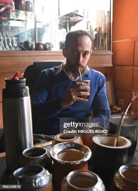 Federico Bresciani owner of traditional handmade silverware store "Bresciani" drinks mate at his workshop in Montevideo on June 27, 2018. - Several...