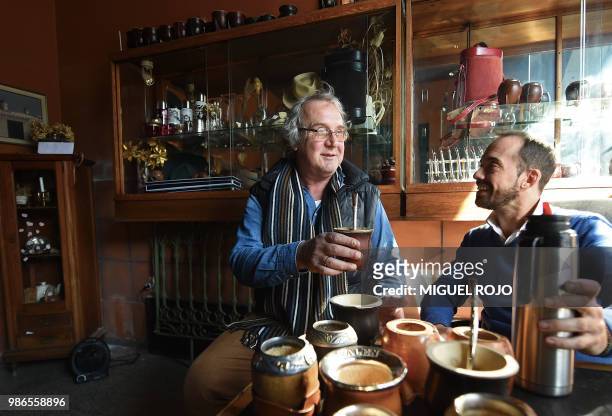 Jorge Francisco and Federico Bresciani manager and owner of traditional handmade silverware store "Bresciani" drink mate at the store in Montevideo...