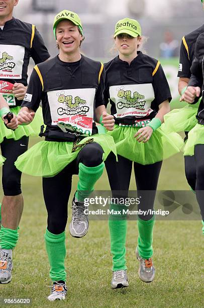 Dave Clark and HRH Princess Beatrice of York wear green tutus and baseball caps as they warm up prior to running the Virgin London Marathon in the...