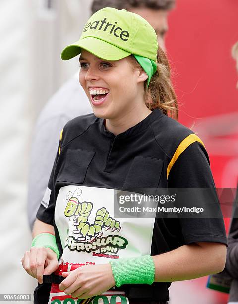 Princess Beatrice of York laughs as she prepares to run the Virgin London Marathon in the 'Caterpillar Run Team', a team of 32 runners tethered...