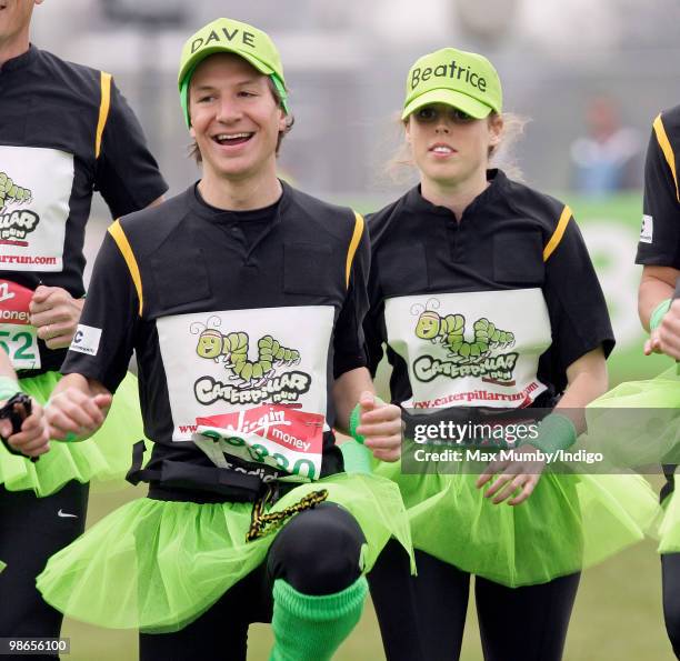 Dave Clark and HRH Princess Beatrice of York wear green tutus and baseball caps as they warm up prior to running the Virgin London Marathon in the...