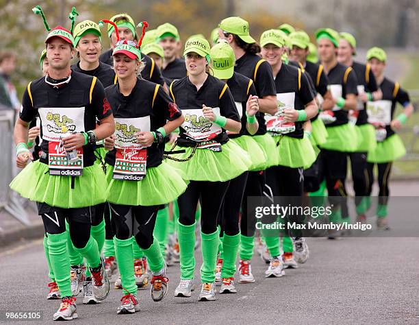 Sam Branson, Holly Branson and HRH Princess Beatrice of York wear green tutus and baseball caps as they warm up prior to running the Virgin London...