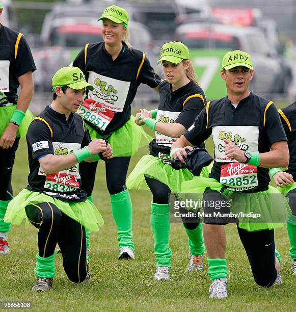 Sam Waley-Cohen and HRH Princess Beatrice of York wear green tutus and baseball caps as they warm up prior to running the Virgin London Marathon in...