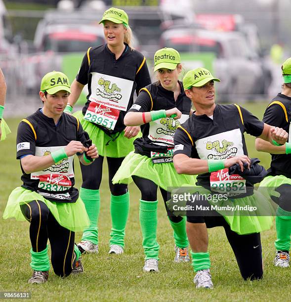 Sam Waley-Cohen and HRH Princess Beatrice of York wear green tutus and baseball caps as they warm up prior to running the Virgin London Marathon in...