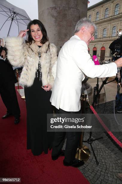 Prof. Dr. Marion Kiechle, Minister CSU, waits until her husband Marcel Reif gives an live interview during the opening of the opera festival and...