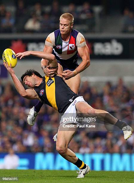 Chris Newman of the Tigers marks in front of Adam McPhee of the Dockers during the round five AFL match between the Fremantle Dockers and the...