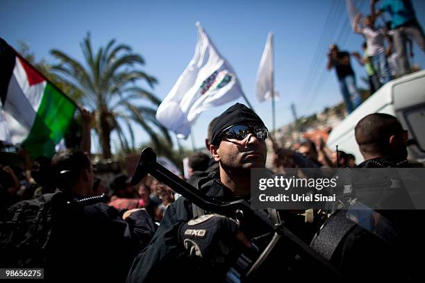 An Israeli riot policeman looks on as right wing nationalist Israelis march through the Arab east Jerusalem neighbourhood of Silwan under heavy...